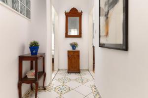 a hallway with a table and a mirror on a wall at Sun Spalato Fara in Hvar
