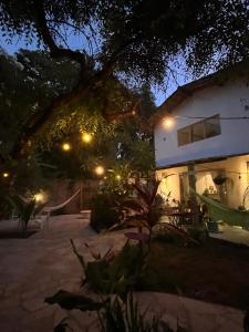 a house with lights in front of it at night at Casinha da Fabi - Suítes in Pipa +29 photos