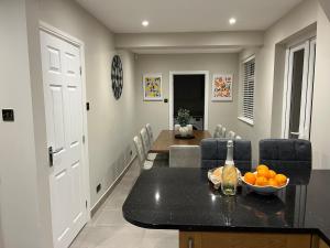 a dining room with a table with a bowl of oranges on it at 6 Bedroom Luxury Home in Olton +20 photos