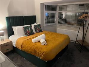 a bedroom with a bed with two towels on it at 6 Bedroom Luxury Home in Olton