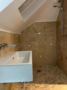 a bathroom with a large white tub and a shower at 6 Bedroom Luxury Home in Olton