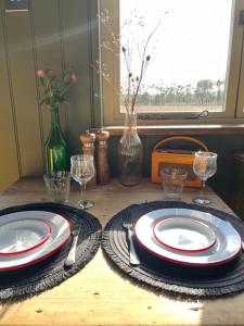 a table with plates and utensils on a table at 'Bramley' Hut on private farm in Charsfield +21 photos