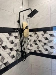 a shower with a blow dryer in a bathroom at MKB Homestay - 2 X King Bed Studio Room with view & FREE parking in Shah Alam