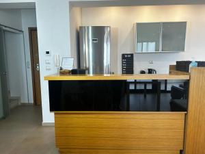 a kitchen with a counter with a refrigerator at Vista mare by Oikies Rentals in Neoi Epivates