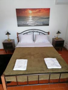a bedroom with a bed with two towels on it at Stephany's Skyline Studio in Parikia