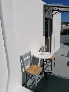 a white table and chairs on a balcony at Stephany's Skyline Studio in Parikia