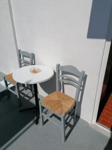 a table and two chairs and a white table and chairs at Stephany's Skyline Studio in Parikia