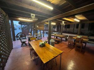 a large room with tables and chairs in a building at Old City Guest House in Sukhothai