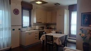 A kitchen or kitchenette at NSM Casa di Fulmine attico con box privato