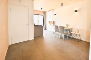 a living room with a table and a dining room at Vizazi Loft in Dambani