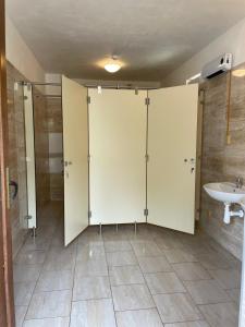 a bathroom with a shower and a toilet and a sink at Kemp U Hrocha in Mladotice +16 photos