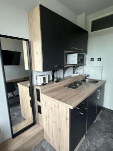 a kitchen with a wooden counter top in a room at Serviced Apartments Mecklenheide in Hannover