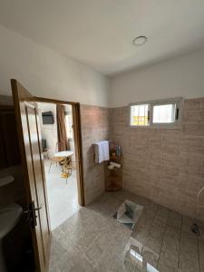 a bathroom with a shower with a sink and a mirror at Chambre La Villa Kalanga in Abidjan +33 photos