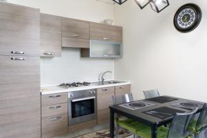 a kitchen with a table and a stove top oven at Very central in Altamura