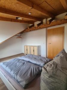 a bedroom with a large bed and a wooden ceiling at Ferienwohnung Sankt Georg in Bad Staffelstein