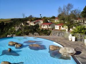 a swimming pool with rocks in the water at Panaroma View in Graskop