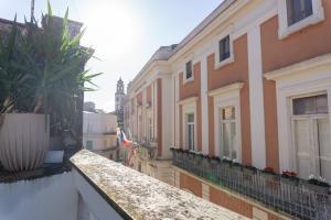 a row of buildings with plants on a balcony at Very central in Altamura +10 photos