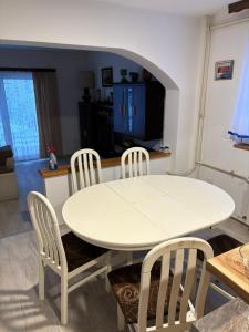 a white table and chairs in a living room at Komforna kuca Pale in Pale +8 photos