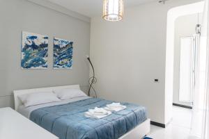 a bedroom with a bed with a blue blanket at Very central in Altamura
