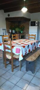 a table with a table cloth on it with chairs at L'Essentiel in Arbusigny +4 photos