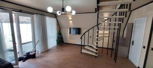 a hallway with a spiral staircase in a house at White A-frame in Çilǝgir