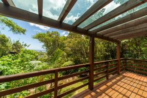 a wooden deck with a view of the ocean at Coração da Terra Praia do Rosa in Praia do Rosa