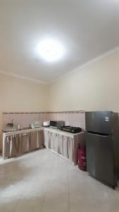 an empty room with a kitchen with a counter top at Radissa Homestay Bandung in Bandung