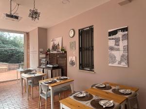 a dining room with tables and chairs and a clock at BB Nuova Villa Paradiso in Urbino
