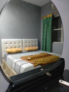 a bedroom with a bed in a mirror at Kouzui Homestay in Surabaya