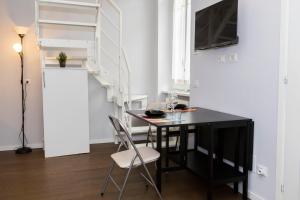 a dining room with a black table and chairs at Italstay - Disciplini Duplex - 10 min dal Duomo in Milan