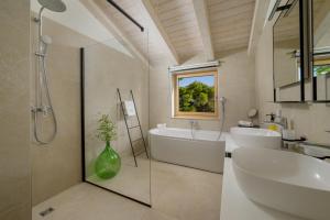 a bathroom with a shower and a sink and a tub at Villa Vista Rovinj - NEW 2024 ! in Rovinj +44 photos