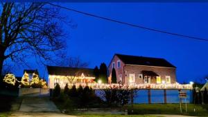 a house with christmas lights on a bridge at Old Village House in Suza