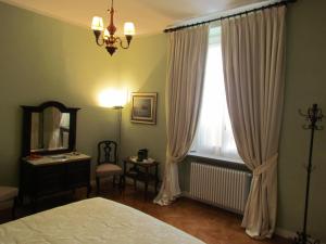 a bedroom with a bed and a mirror and a window at Al Porticciolo di Sant'Agostino in Como