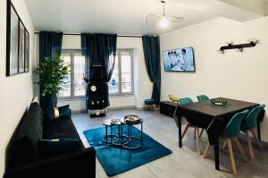a living room with a couch and a table at Le Cocon Saint-Pierre in Pontarlier