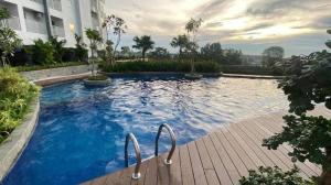 a large pool with blue water in front of a building at Our Home in Jodoh