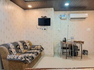 a living room with a couch and a table at LD Guest House, Ayodhya in Ayodhya