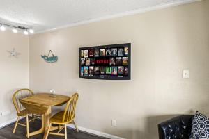 a dining room with a table and chairs at Heated Pool Beach View Beachside Haven Balcony in Galveston