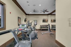 a fitness room with treadmills and ellipticals at Chic 2BR- Pool,Gym,Pkng,Near BOK Ctr&Arts Dstrct in Tulsa