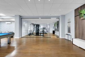 an empty room with a pool table and a gym at Sleek 1BR Near BOKCenter-Gym,Lounge,Balcony,PetOK in Tulsa