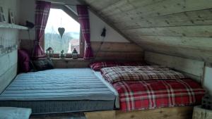 a bedroom with two beds in a attic at Apartmany Bublava 817 in Bublava