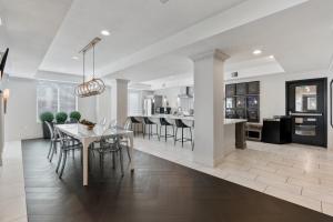 a kitchen and living room with a table and chairs at Modern 1BR w Parking, Near Temple Square & Delta Center in Salt Lake City