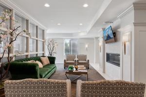 a living room with a green couch and chairs at Modern 1BR w Parking, Near Temple Square & Delta Center in Salt Lake City