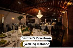 a dining room with a table with plates of food at Cozy 1BR Parking, Rooftop, Near Arrowhd & TMobile in Kansas City