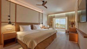 a hotel room with a large bed and a window at PortoBay Blue Ocean in Albufeira +37 photos