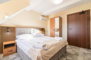 Postel nebo postele na pokoji v ubytování Hotel Perła Dunajca