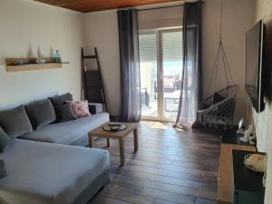 a living room with a couch and a table at Kuća za odmor SeaHouse in Karlobag
