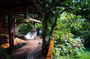 a porch with a hammock hanging from a tree at Amaraka Lodge in Leandro N. Alem