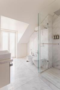 a bathroom with a shower and a sink and a toilet at Chiado Square Apartments | Lisbon Best Apartments in Lisbon +66 photos