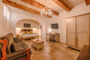 a living room with a bed and a couch at Mulberries in Żabbar