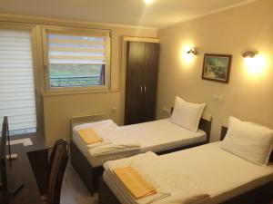 a room with two beds and a window at Prenociste Gazela in Pirot +54 photos